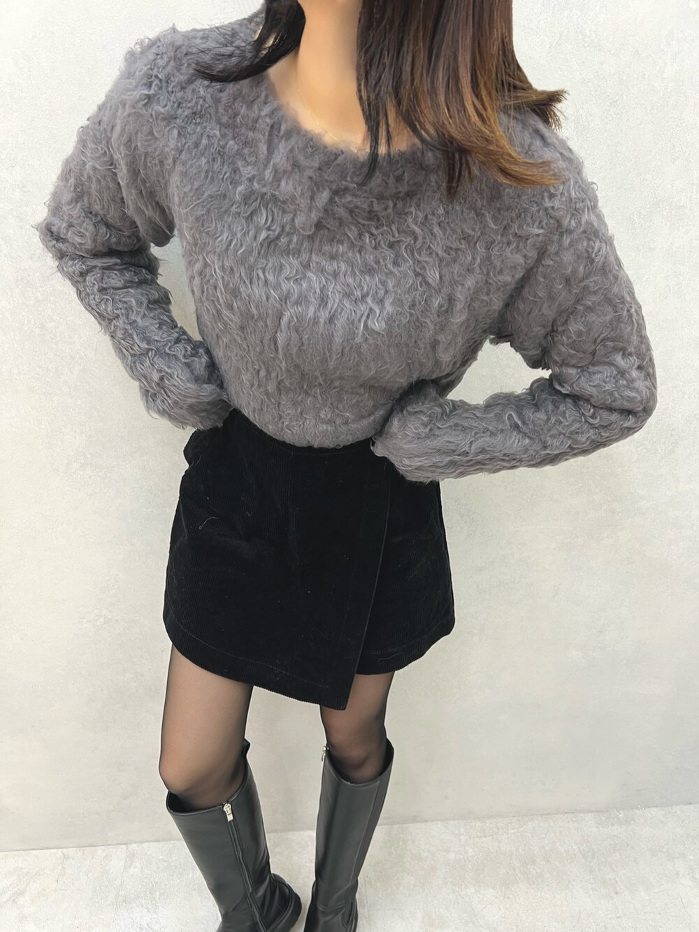 グレー系のニット/セーター、シルバー系のベルトを着用したレディースの冬コーディネートの3枚目の写真