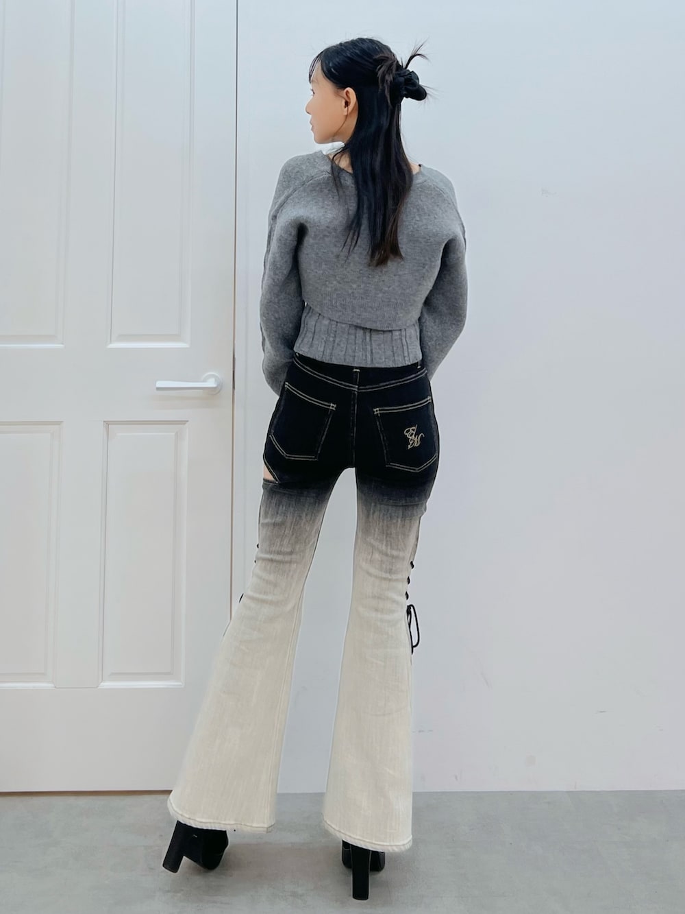 その他のデニムパンツ、グレー系のニット/セーター、ブラック系のブーツを着用したレディースの冬コーディネートの3枚目の写真