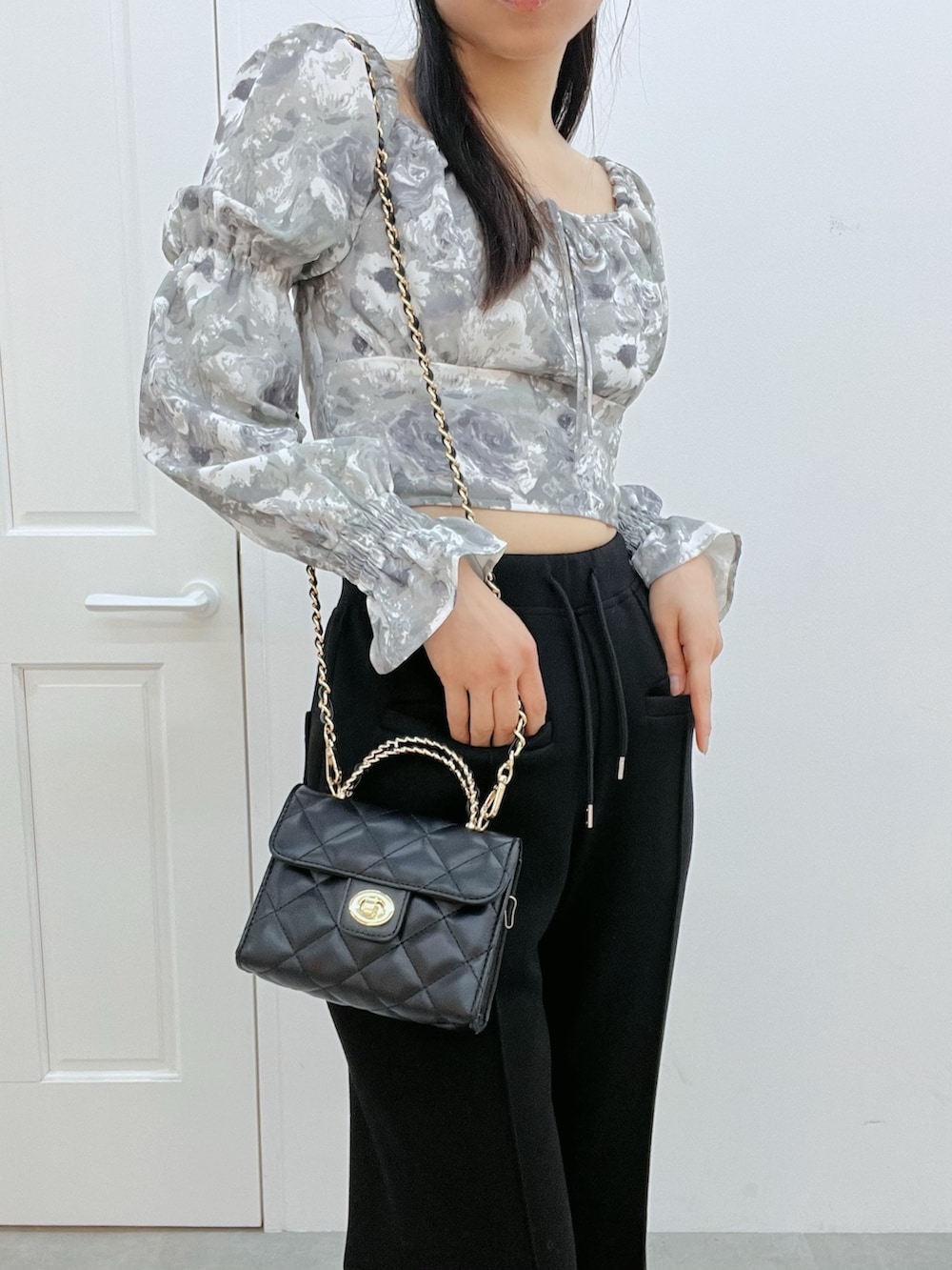 グレー系のシャツ/ブラウス、ブラック系のその他パンツ、ブラック系のハンドバッグを着用したレディースの冬コーディネートの5枚目の写真