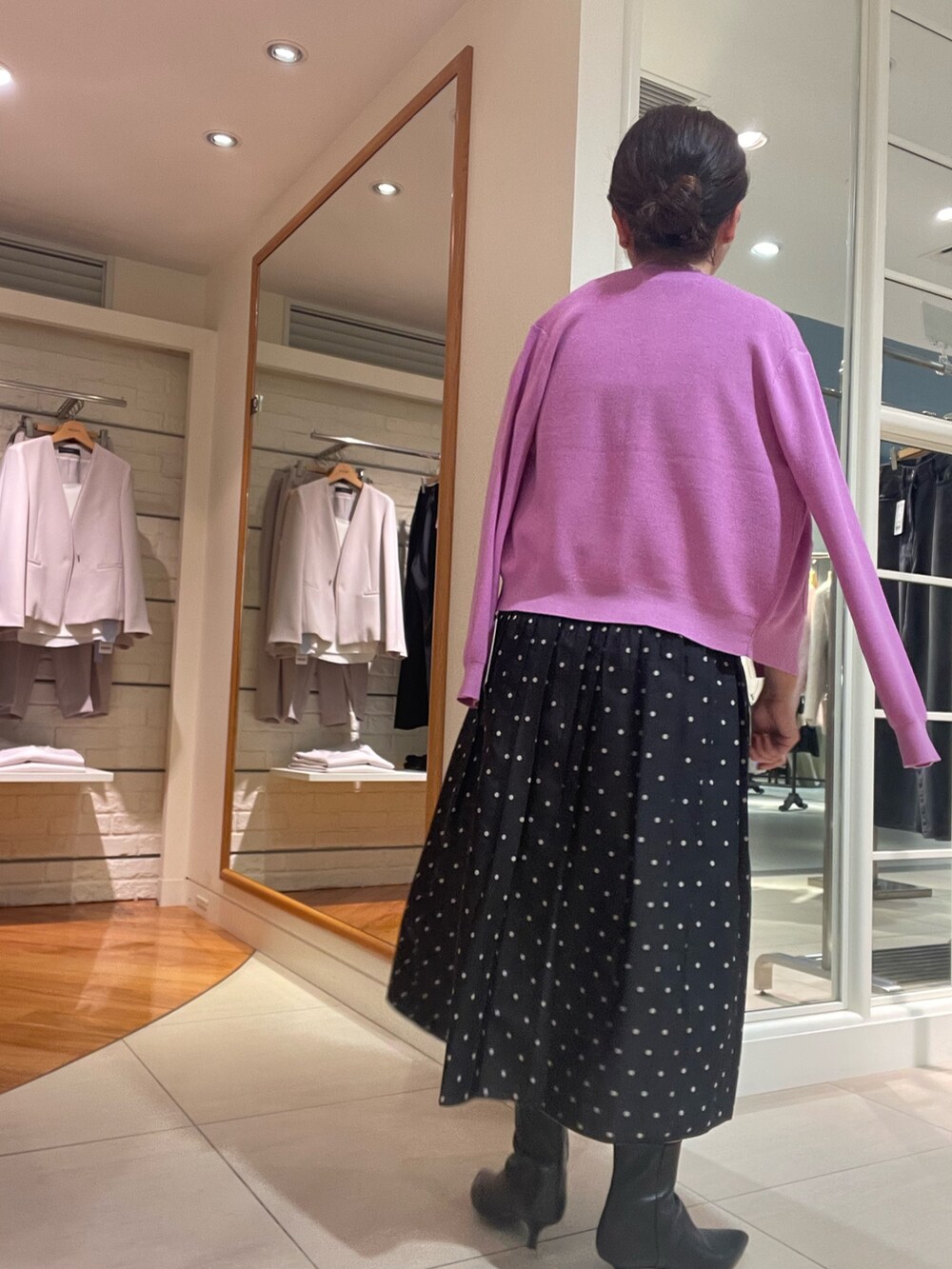 ピンク系のカーディガン/ボレロ、ピンク系のニット/セーター、ブラック系のスカートを着用したレディースの秋コーディネートの5枚目の写真