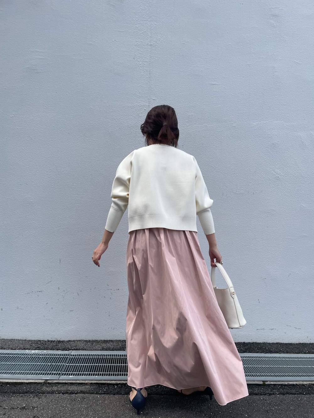 ホワイト系のカーディガン/ボレロ、ピンク系のスカート、オレンジ系のショルダーバッグを着用したレディースの春コーディネートの3枚目の写真