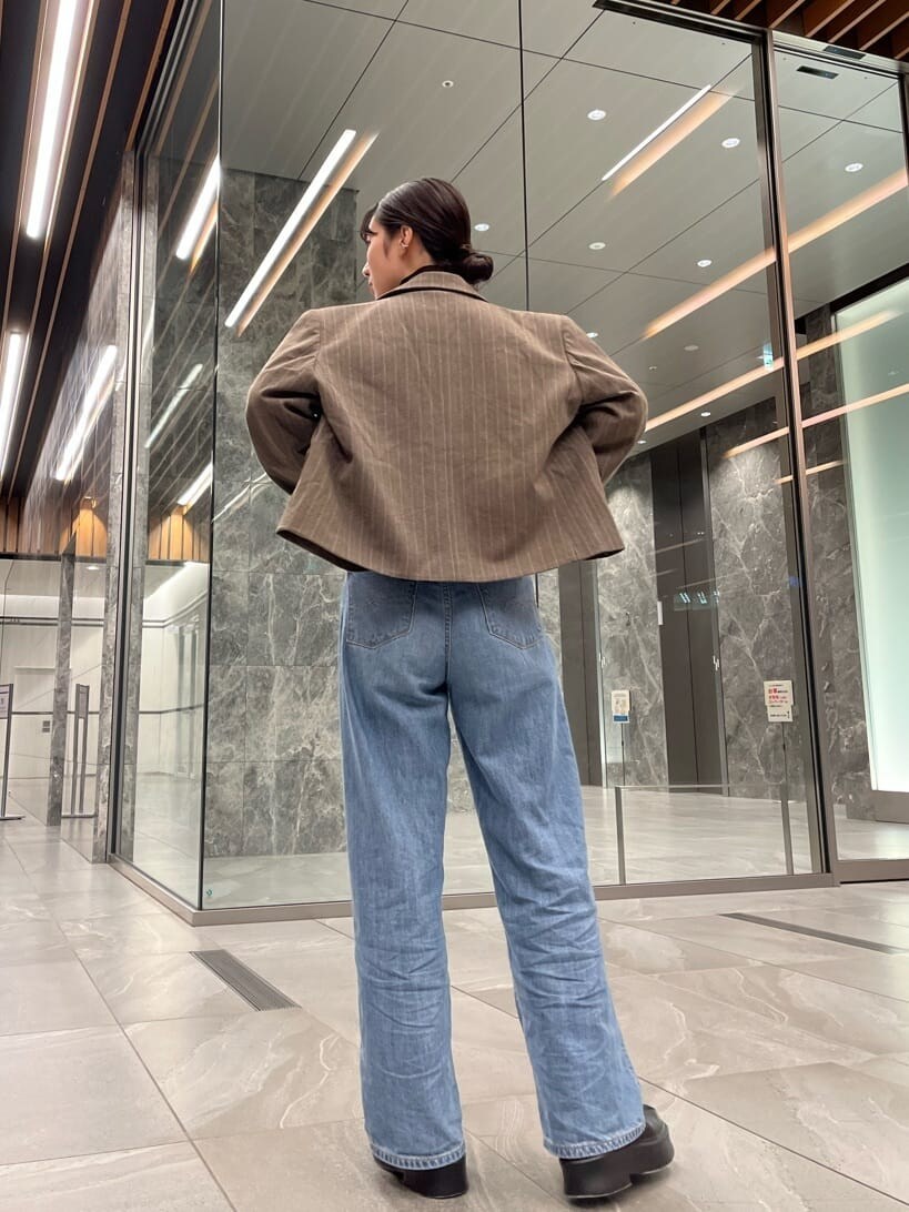 ブルー系のデニムパンツ、ブルー系のデニムパンツ、ブラック系のTシャツ/カットソーを着用したレディースの秋コーディネートの4枚目の写真