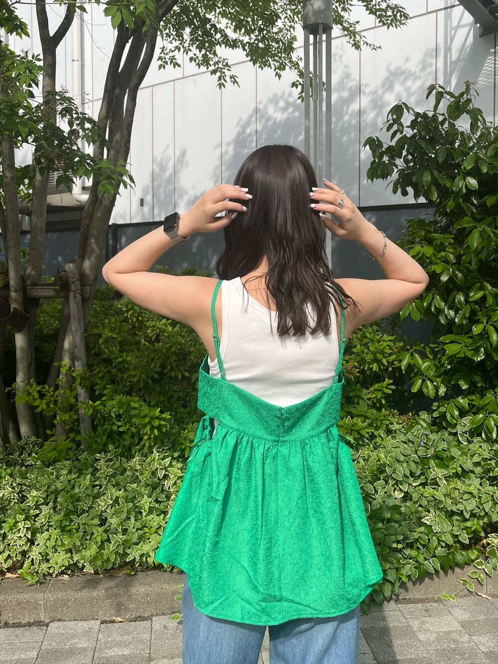 グリーン系のシャツ/ブラウス、ブルー系のデニムパンツを着用したレディースの春コーディネートの4枚目の写真