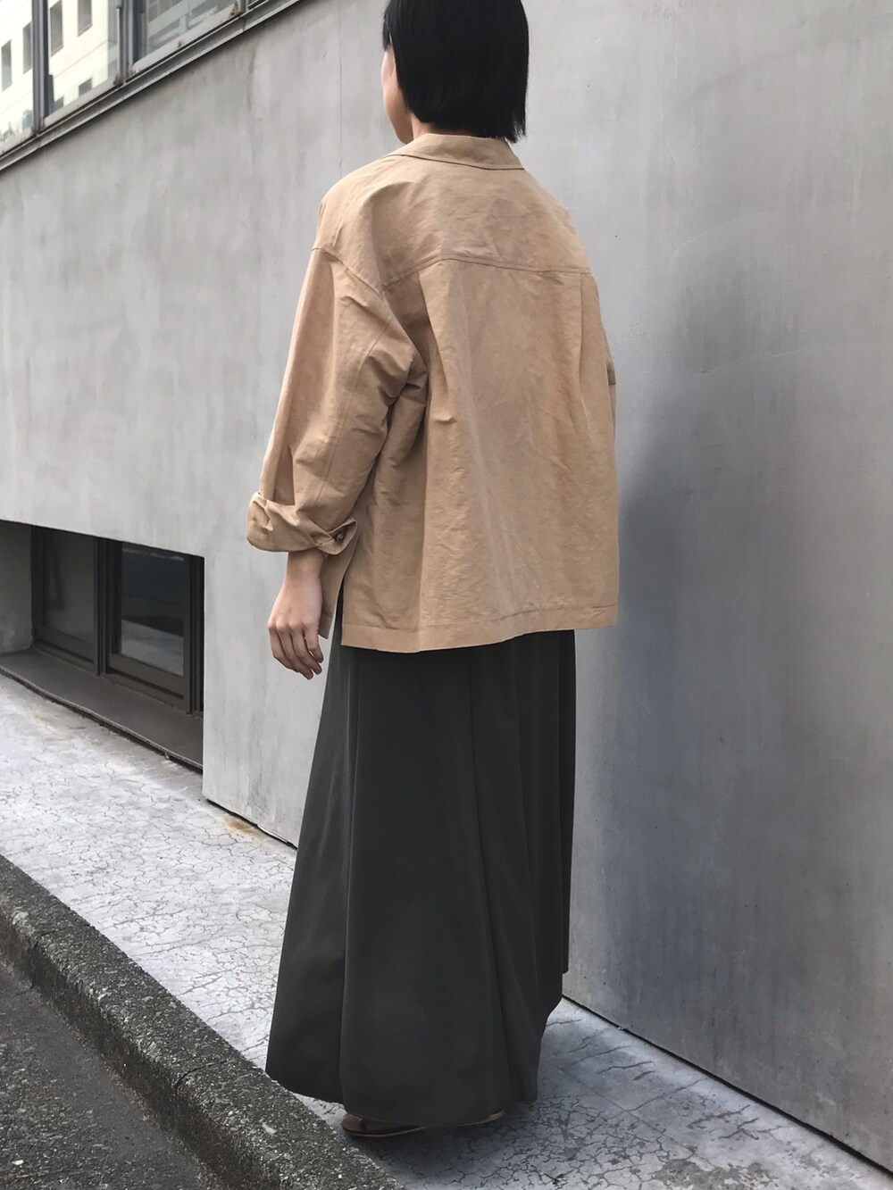 ベージュ系のテーラードジャケット、ホワイト系のシャツ/ブラウス、グリーン系のスカートを着用したレディースの春コーディネートの4枚目の写真