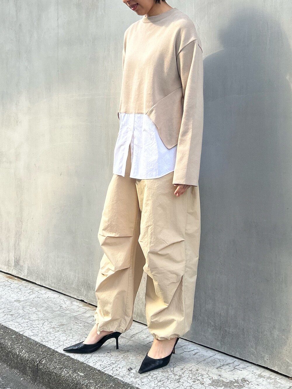 ベージュ系のニット/セーターを着用したレディースの冬コーディネートの2枚目の写真