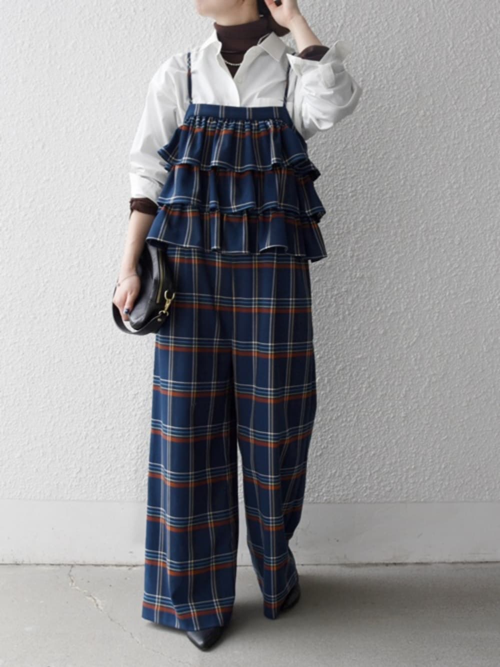 ホワイト系のシャツ/ブラウス、ブラウン系のニット/セーター、ブルー系のサロペット/オーバーオールを着用したレディースの冬コーディネートの2枚目の写真