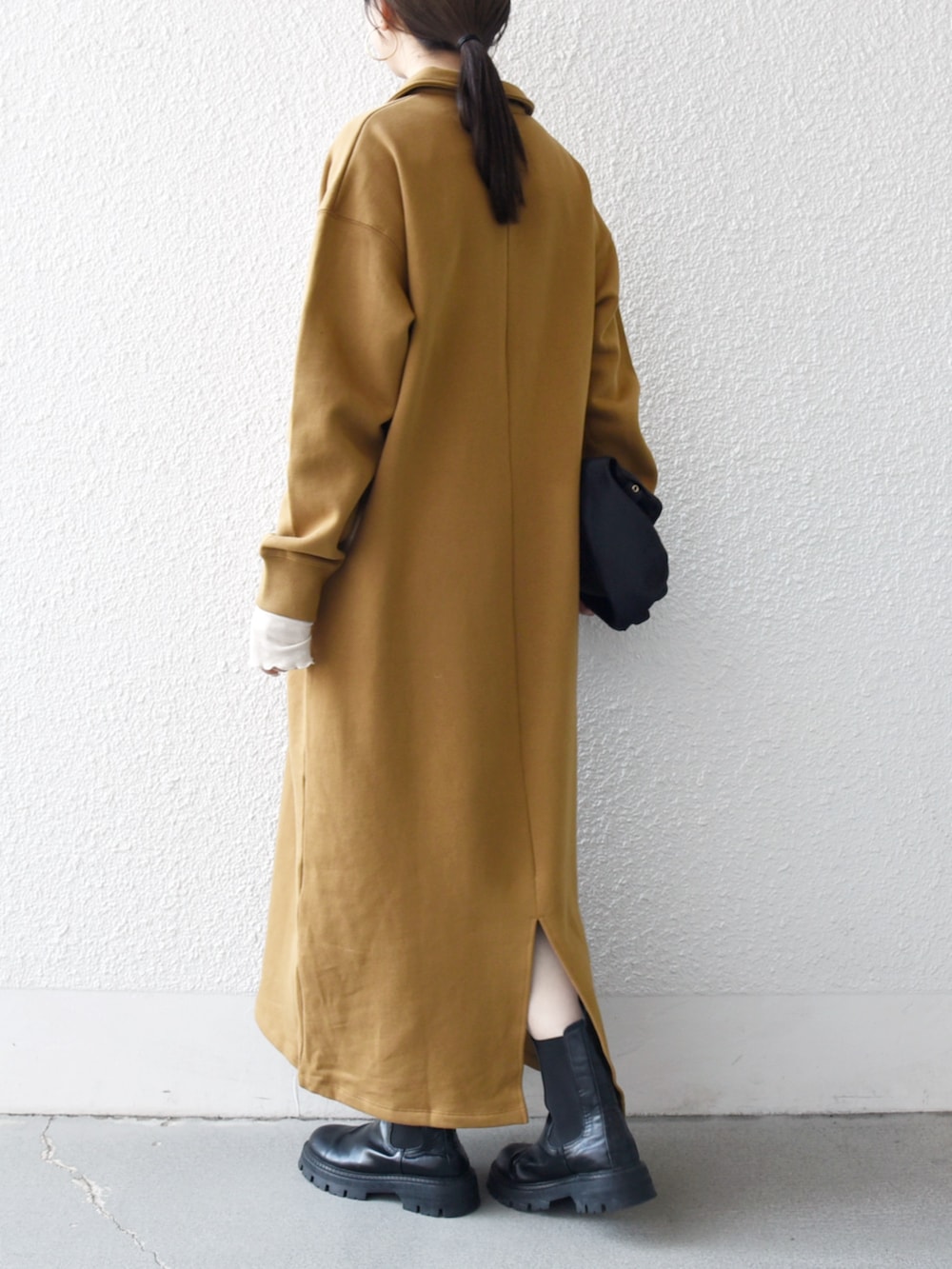 ブラック系のブーツ、イエロー系のワンピース、ブラック系のトートバッグを着用したレディースの秋コーディネートの3枚目の写真