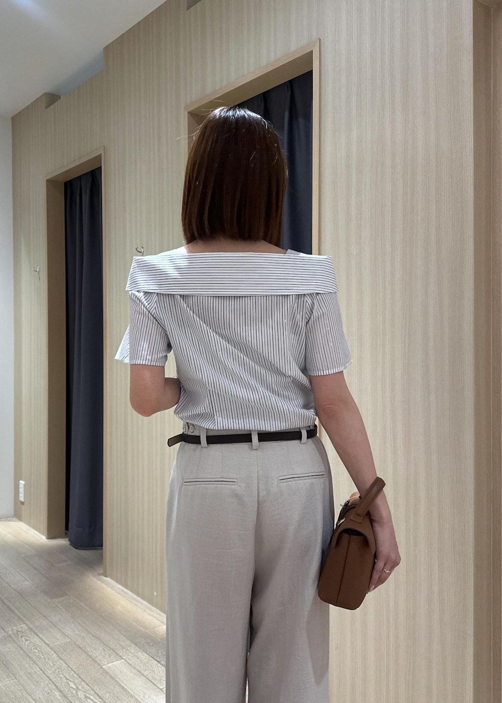 イエロー系のショルダーバッグ、ブラック系のパンプス、ホワイト系のその他パンツを着用したレディースの夏コーディネートの7枚目の写真