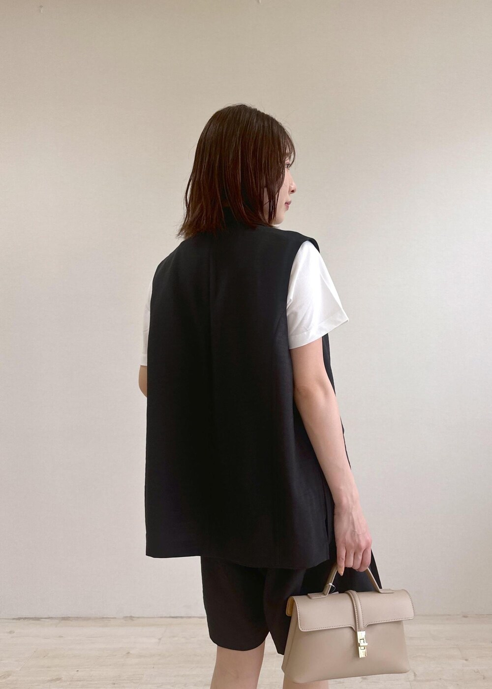 ベージュ系のショルダーバッグ、レッド系のサンダル、ホワイト系のTシャツ/カットソーを着用したレディースの春コーディネートの6枚目の写真