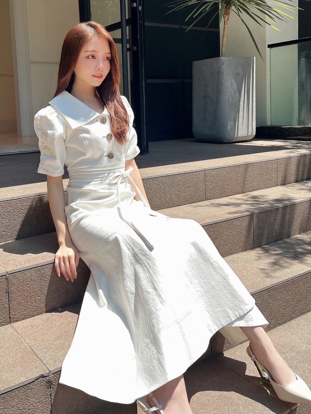 ホワイト系のワンピース、ホワイト系のサンダルを着用したレディースの夏コーディネートの4枚目の写真