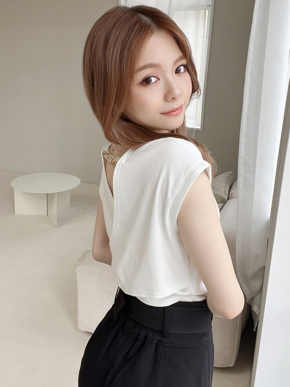 ホワイト系のTシャツ/カットソー、ホワイト系のサンダル、ブラック系のスカートを着用したレディースの夏コーディネートの2枚目の写真