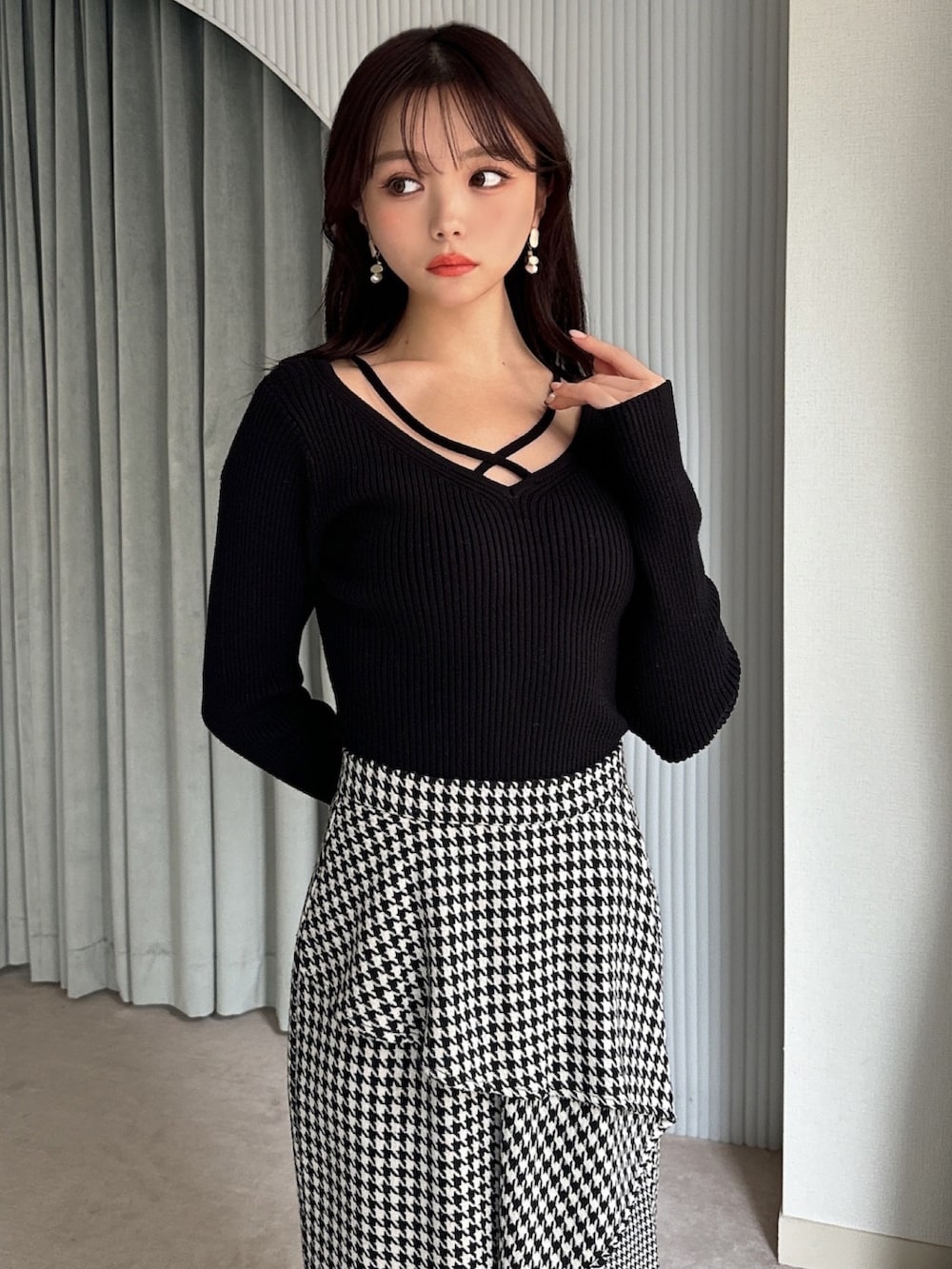 ブラック系のニット/セーター、その他のスカート、ブラック系のパンプスを着用したレディースの冬コーディネートの3枚目の写真