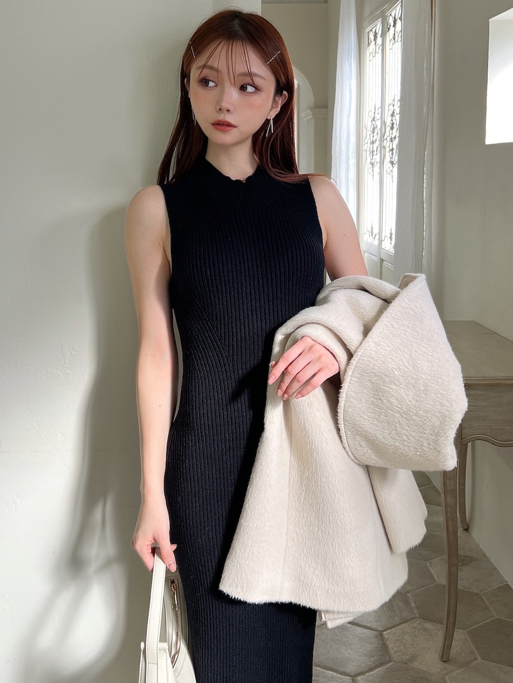 その他のワンピース、ホワイト系のハンドバッグ、ブラック系のブーツを着用したレディースの冬コーディネートの8枚目の写真