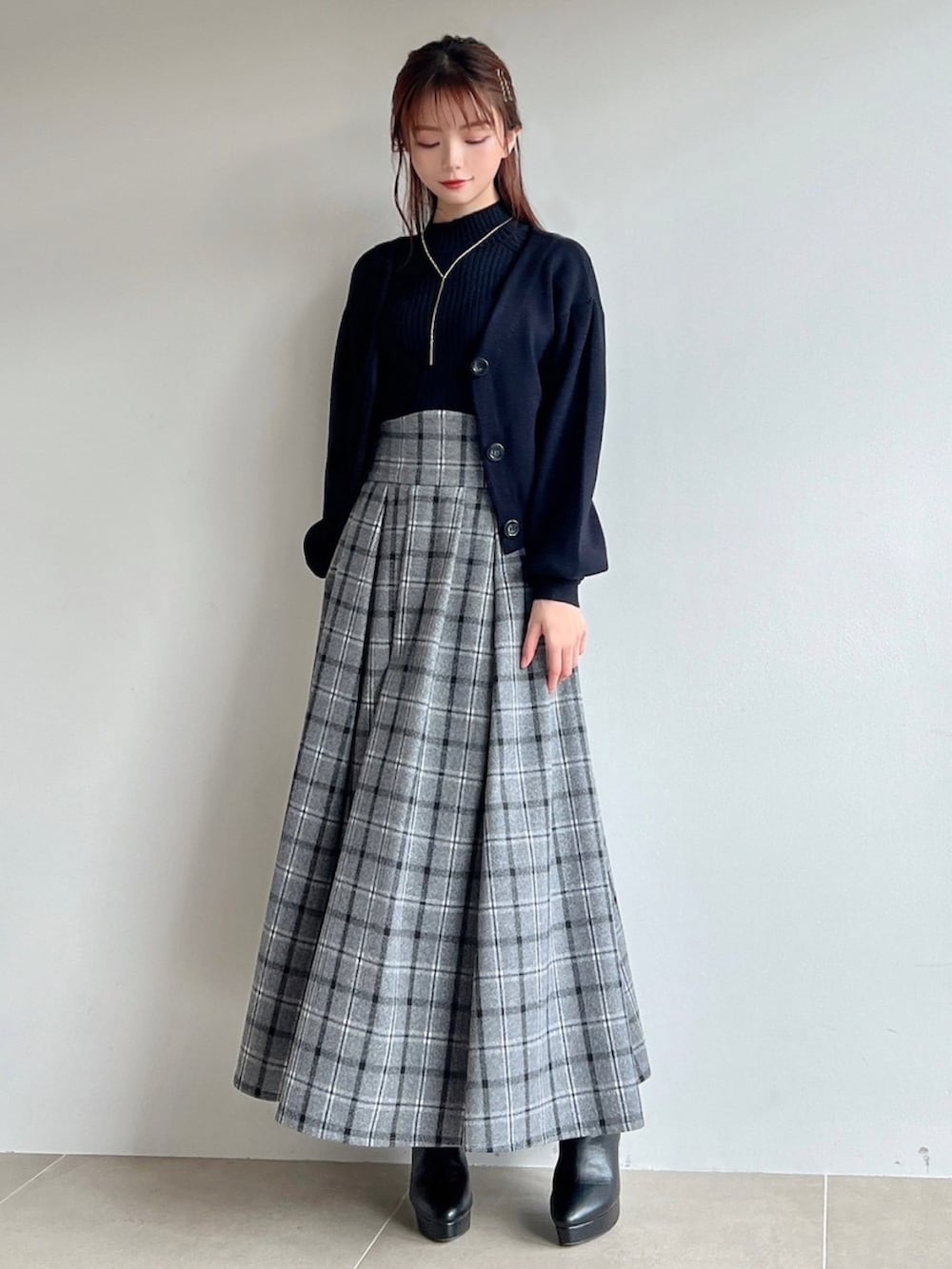 ブラック系のスカート、ブラック系のカーディガン/ボレロ、ブラック系のニット/セーターを着用したレディースの冬コーディネートの3枚目の写真