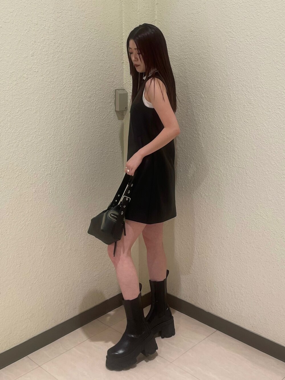 ブラック系のワンピース、ホワイト系のタンクトップ、ブラック系のブーツを着用したレディースの夏コーディネートの4枚目の写真