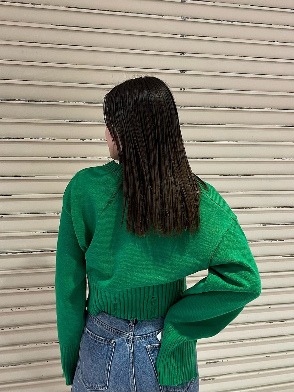 グリーン系のニット/セーターを着用したレディースの冬コーディネートの3枚目の写真