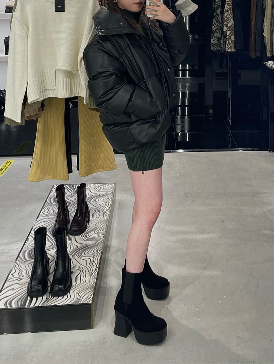 グリーン系のワンピース、ブラック系のブーツ、その他のダウンジャケット/コートを着用したレディースの秋コーディネートの4枚目の写真