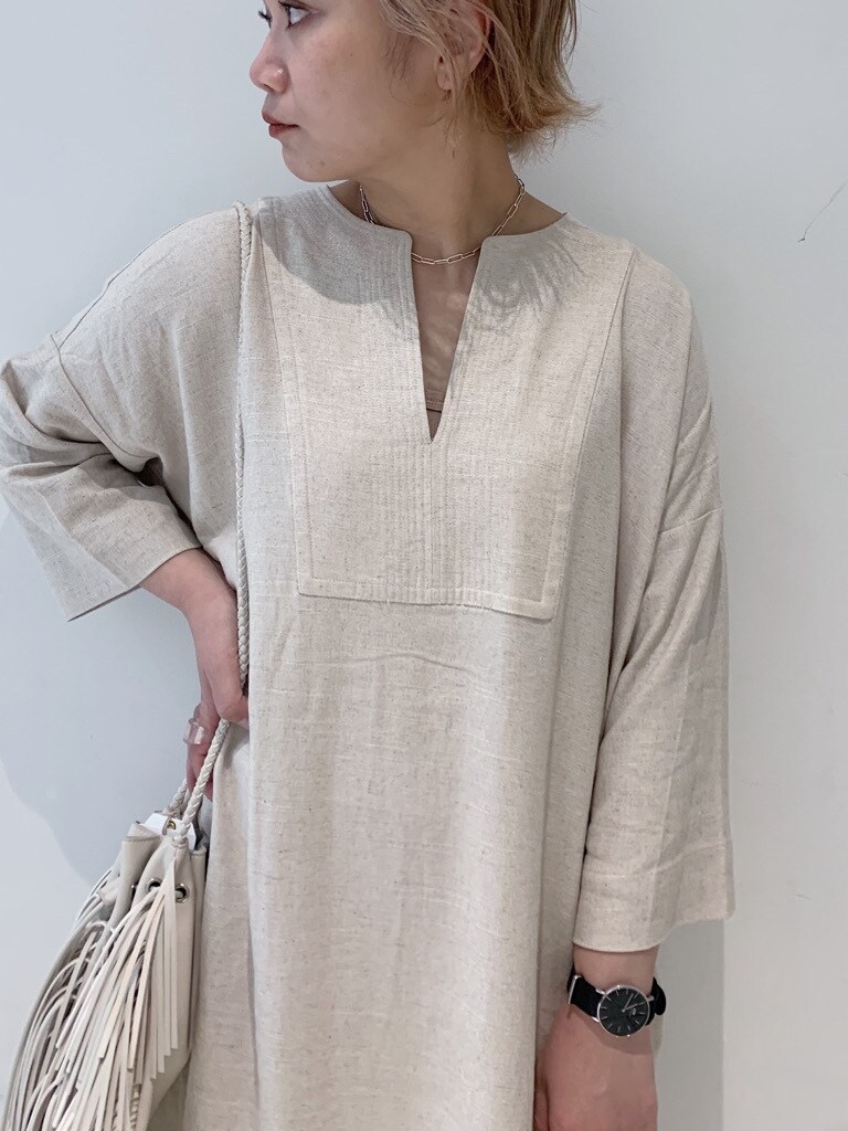 ホワイト系のハンドバッグ、ホワイト系のワンピース、ゴールド系のその他パンツを着用したレディースの春コーディネートの2枚目の写真