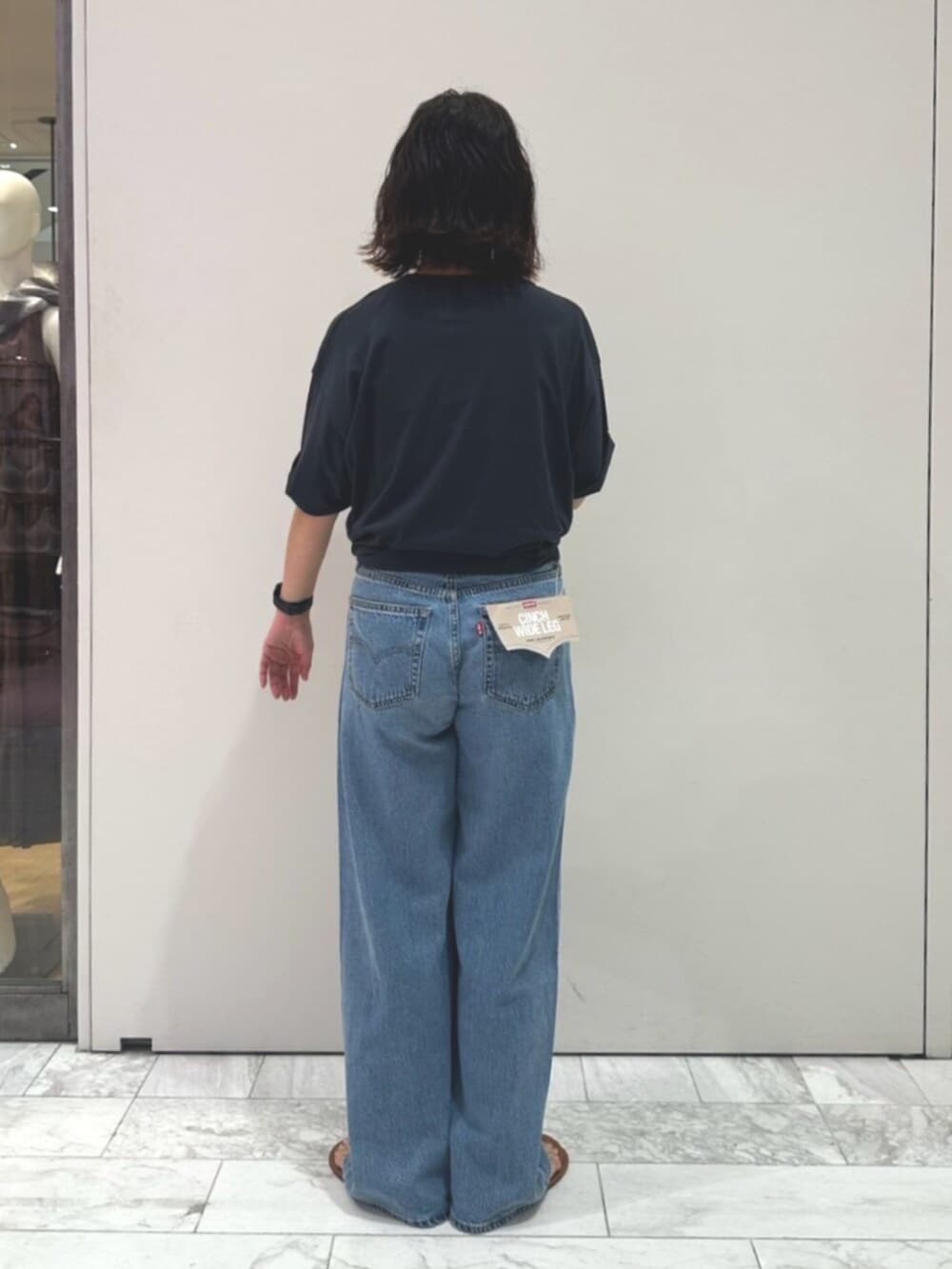ブルー系のデニムパンツ、グレー系のTシャツ/カットソーを着用したレディースの夏コーディネートの3枚目の写真