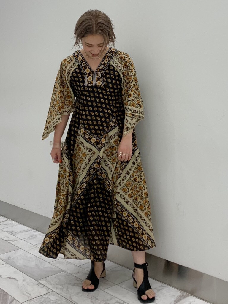 ブラック系のサンダル、イエロー系のワンピースを着用したレディースの夏コーディネートの2枚目の写真