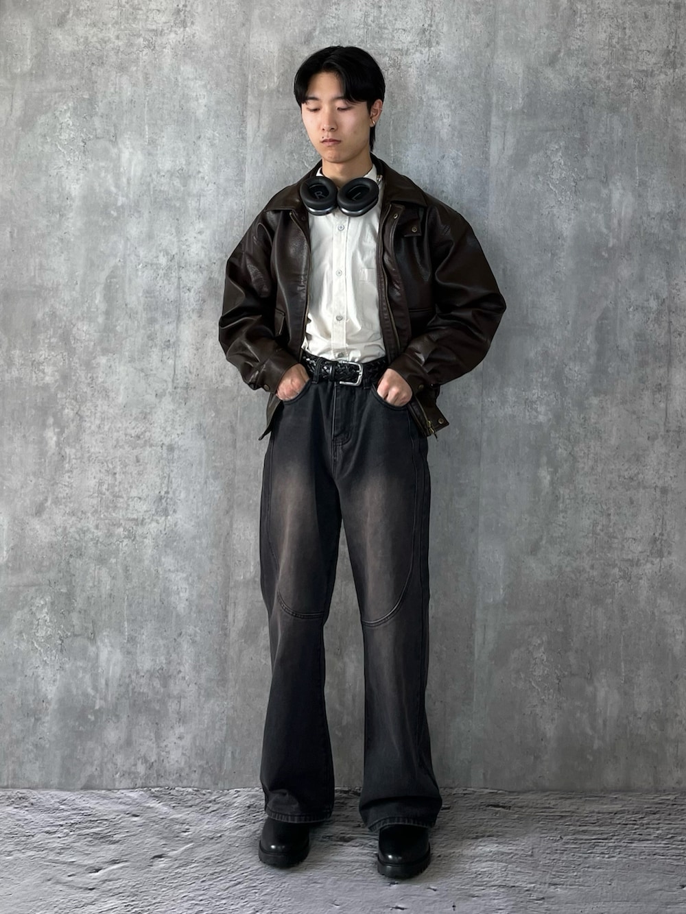 ブラック系のブーツ、ブラック系のデニムパンツ、ブラウン系のブルゾンを着用したメンズの冬コーディネートの2枚目の写真