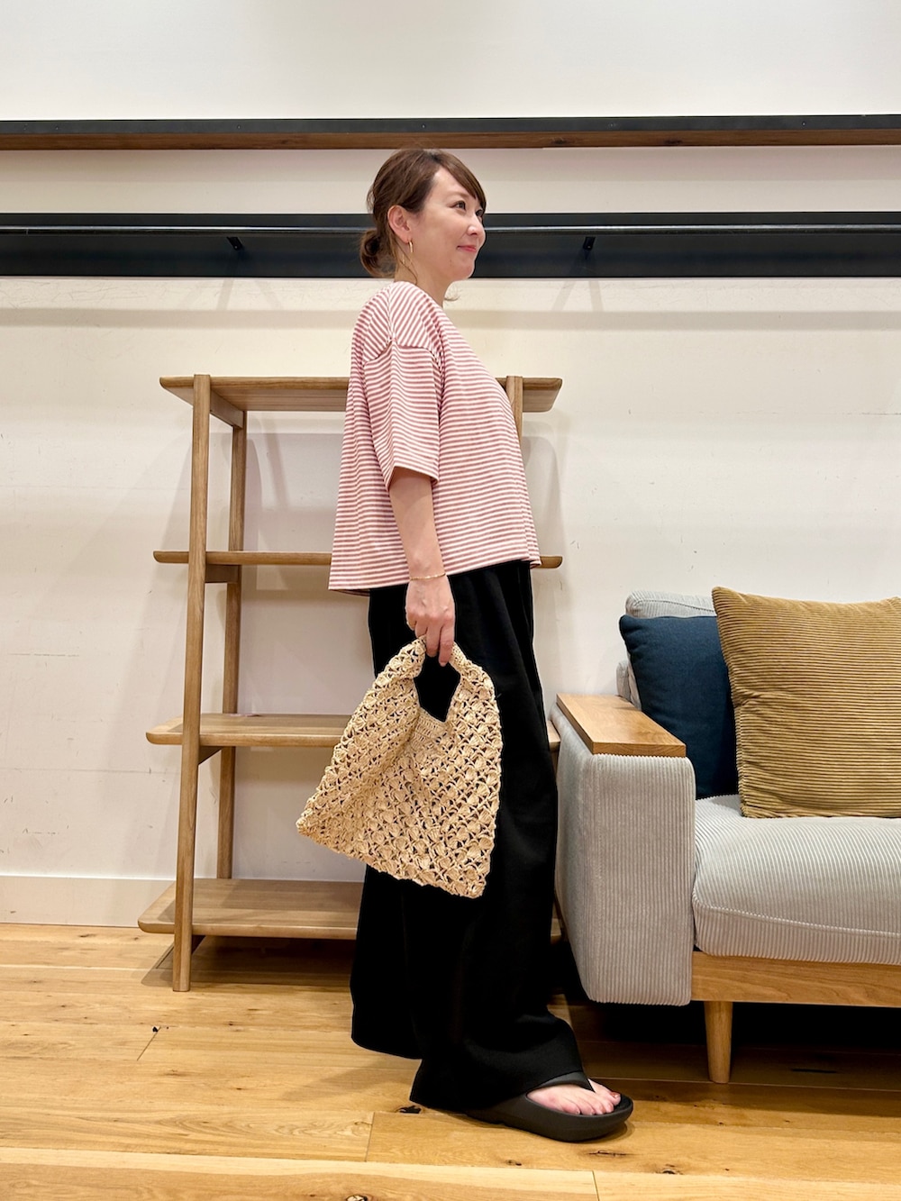 レッド系のTシャツ/カットソー、ブラック系のその他パンツ、ブラック系のサンダルを着用したレディースの春コーディネートの4枚目の写真