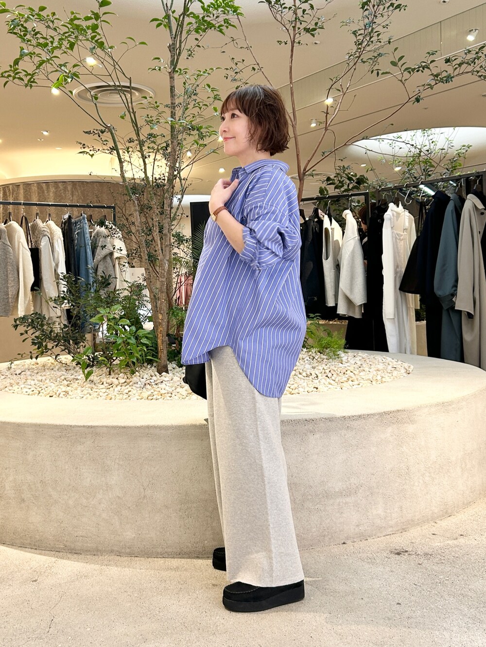 ブルー系のシャツ/ブラウス、ベージュ系のその他パンツ、ブラック系のトートバッグを着用したレディースの秋コーディネートの2枚目の写真