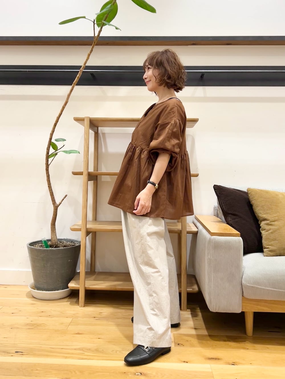 ブラウン系のシャツ/ブラウス、グレー系のその他パンツ、ブラック系のパンプスを着用したレディースの秋コーディネートの2枚目の写真