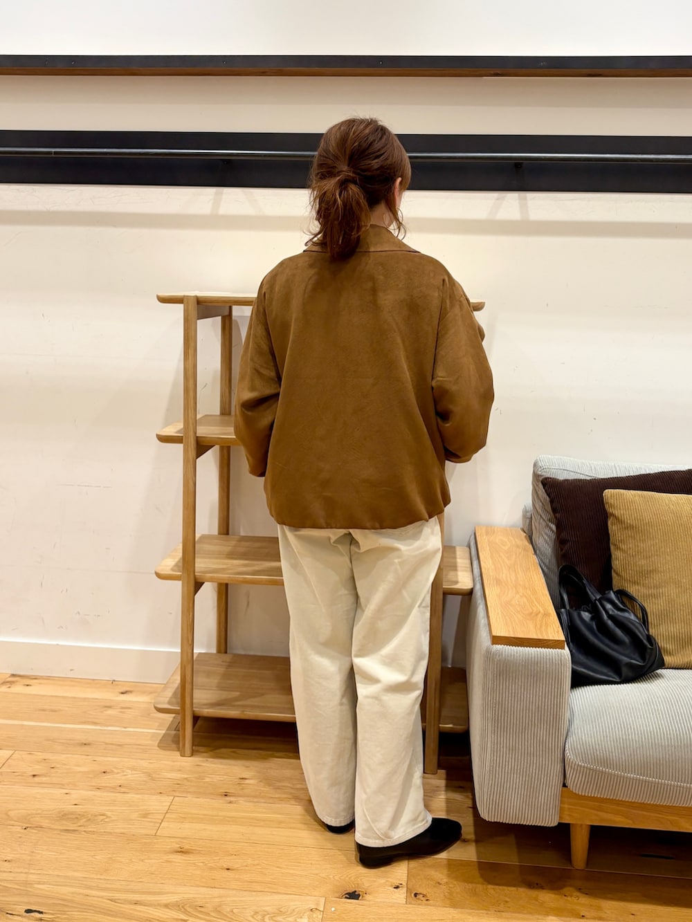 イエロー系のブルゾン、レッド系のニット/セーター、ホワイト系のその他パンツを着用したレディースの秋コーディネートの3枚目の写真