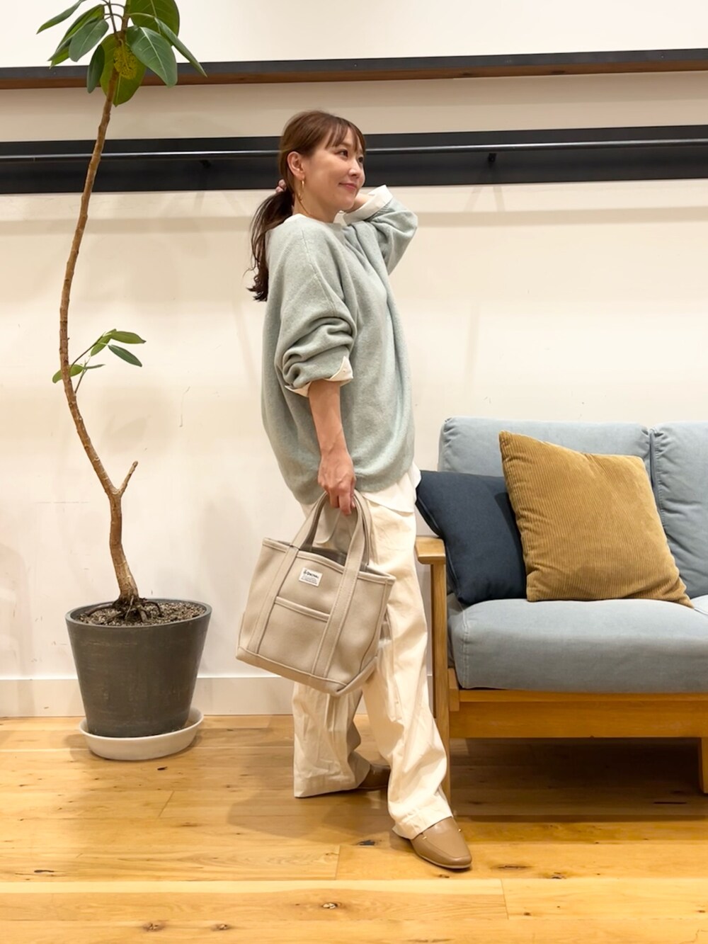 ピンク系のニット/セーター、ベージュ系のデニムパンツを着用したレディースの秋コーディネートの3枚目の写真