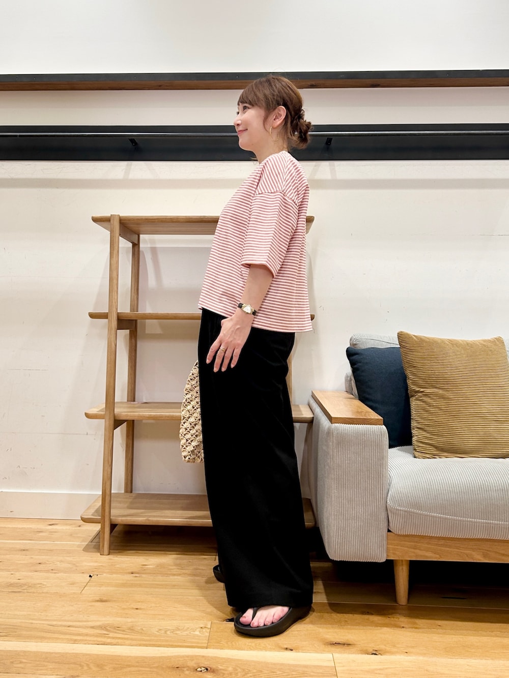 レッド系のTシャツ/カットソー、ブラック系のその他パンツ、ブラック系のサンダルを着用したレディースの春コーディネートの2枚目の写真