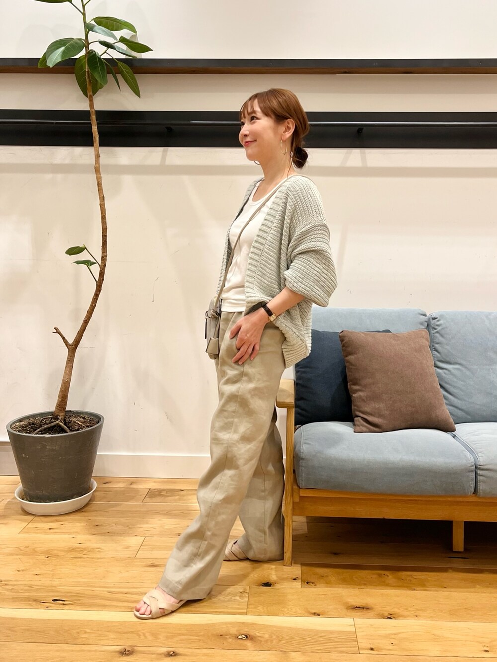 グリーン系のカーディガン/ボレロ、グレー系のショルダーバッグ、ベージュ系のパンツを着用したレディースの春コーディネートの4枚目の写真