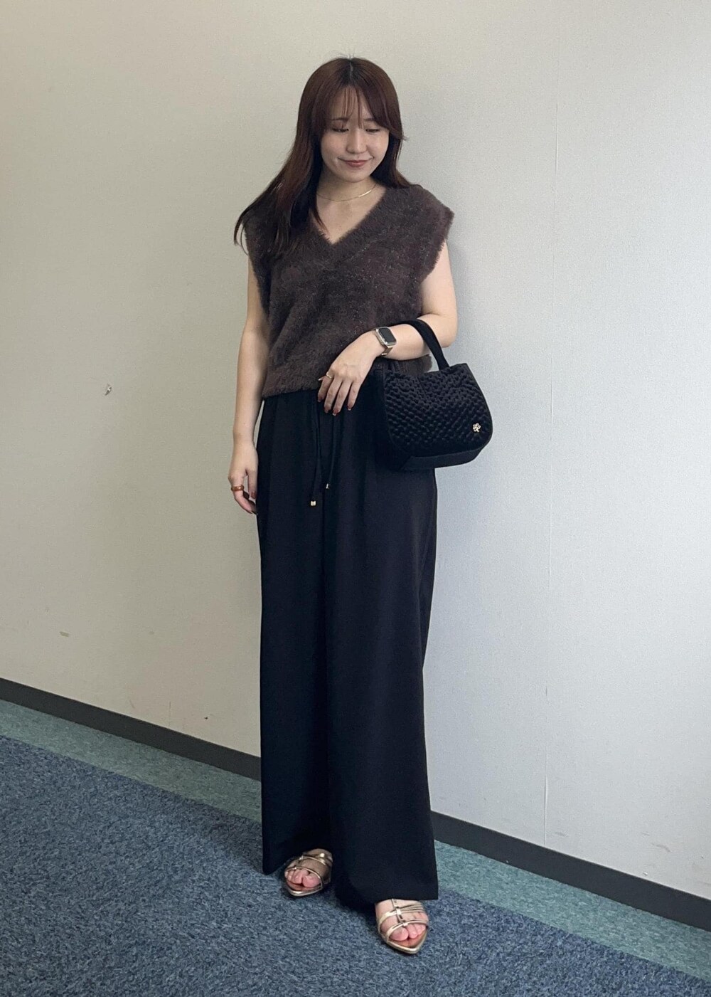 ブラウン系のベスト、ブラック系のその他パンツ、ブラック系のショルダーバッグを着用したレディースの夏コーディネートの4枚目の写真