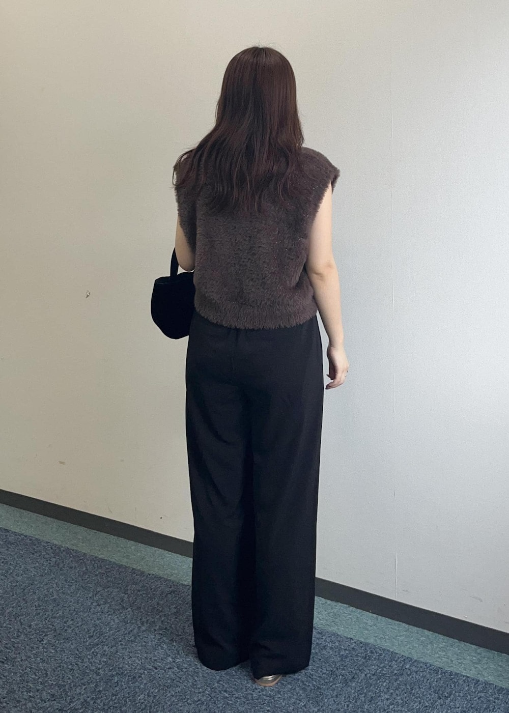 ブラウン系のベスト、ブラック系のその他パンツ、ブラック系のショルダーバッグを着用したレディースの夏コーディネートの6枚目の写真