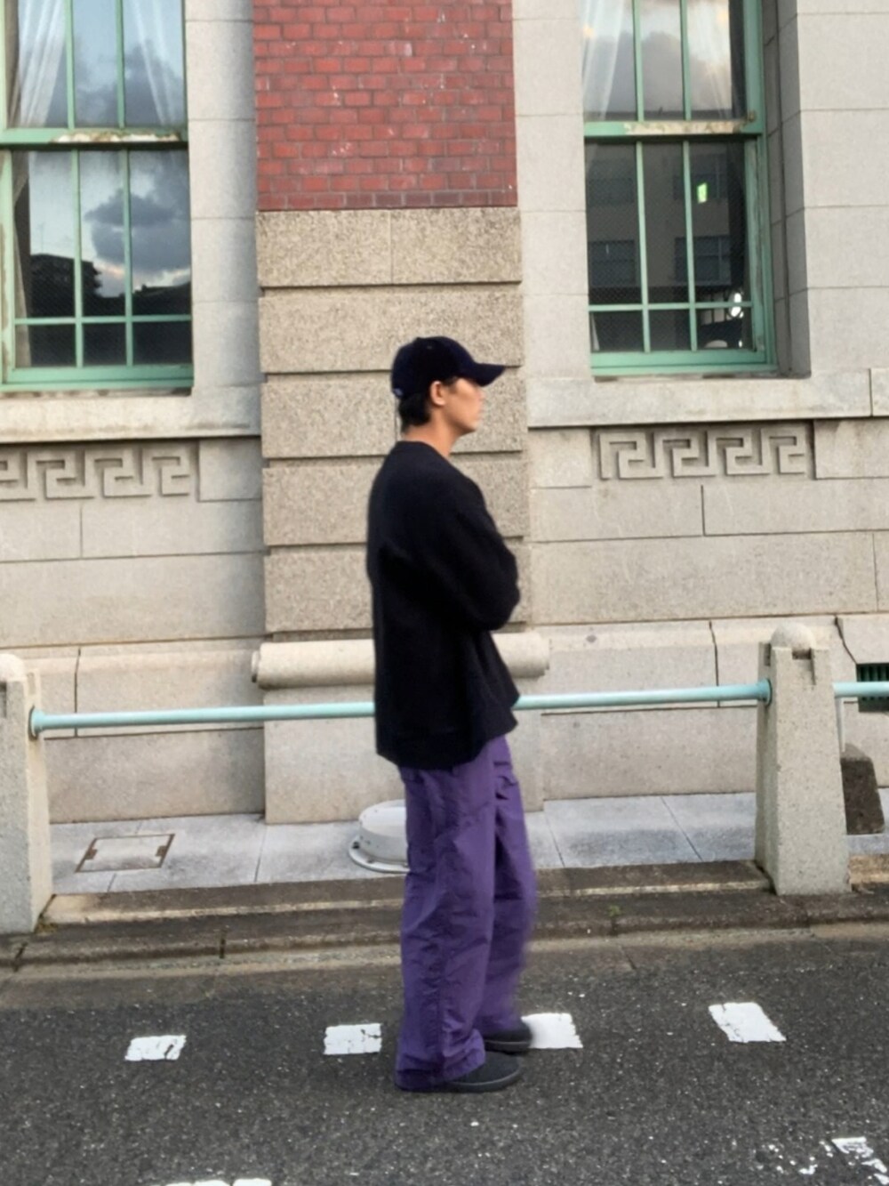 ブラック系のスウェット、ブラック系のスニーカー、ブルー系のキャップを着用したメンズの冬コーディネートの2枚目の写真