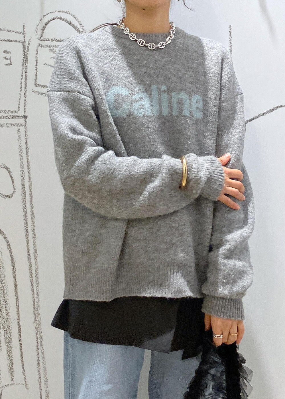 ブルー系のデニムパンツ、ブラック系のパンプス、グレー系のその他パンツを着用したレディースの冬コーディネートの4枚目の写真