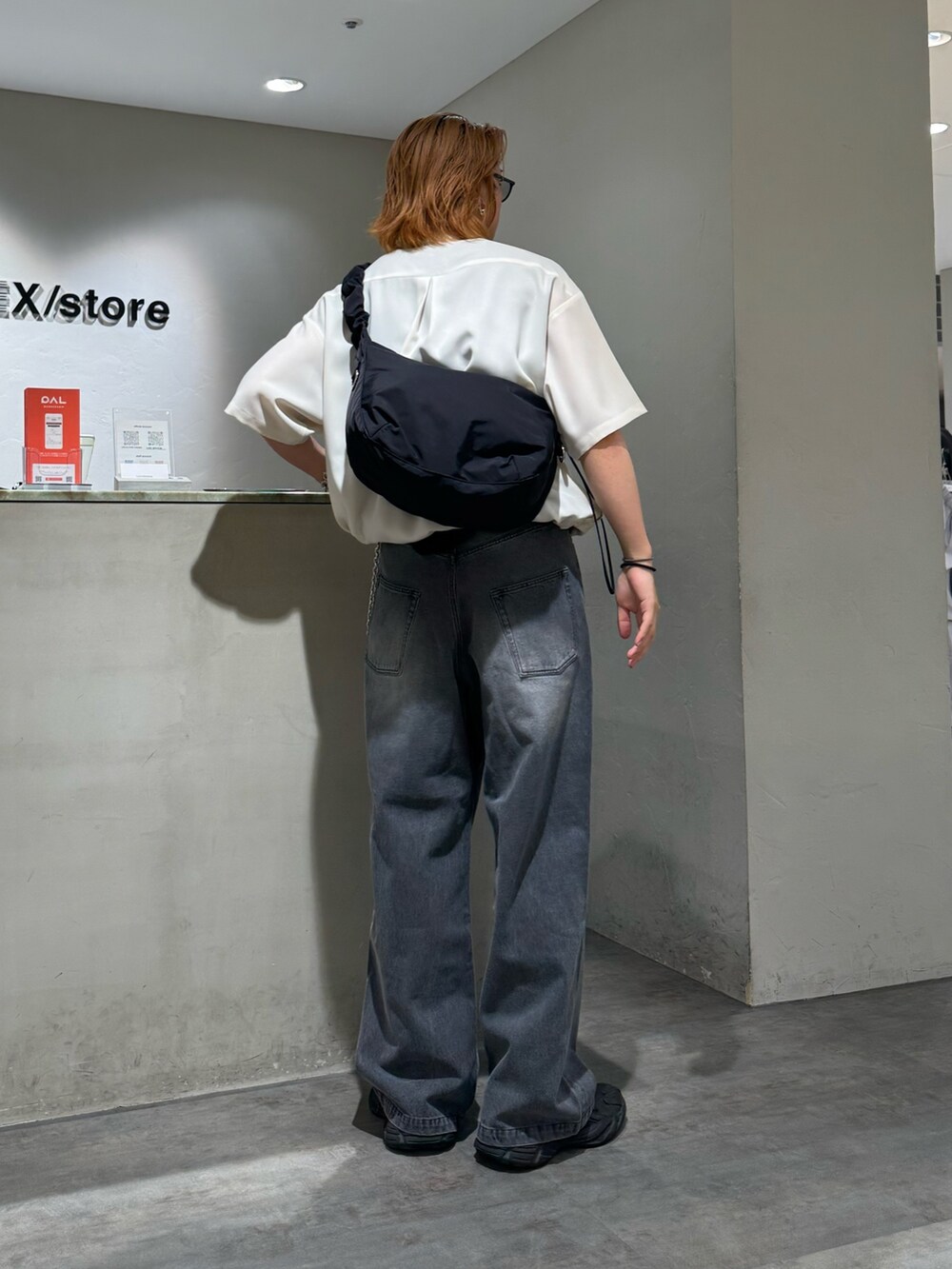 ブラック系のデニムパンツ、ブラック系のショルダーバッグ、グレー系のシャツ/ブラウスを着用したメンズの夏コーディネートの3枚目の写真