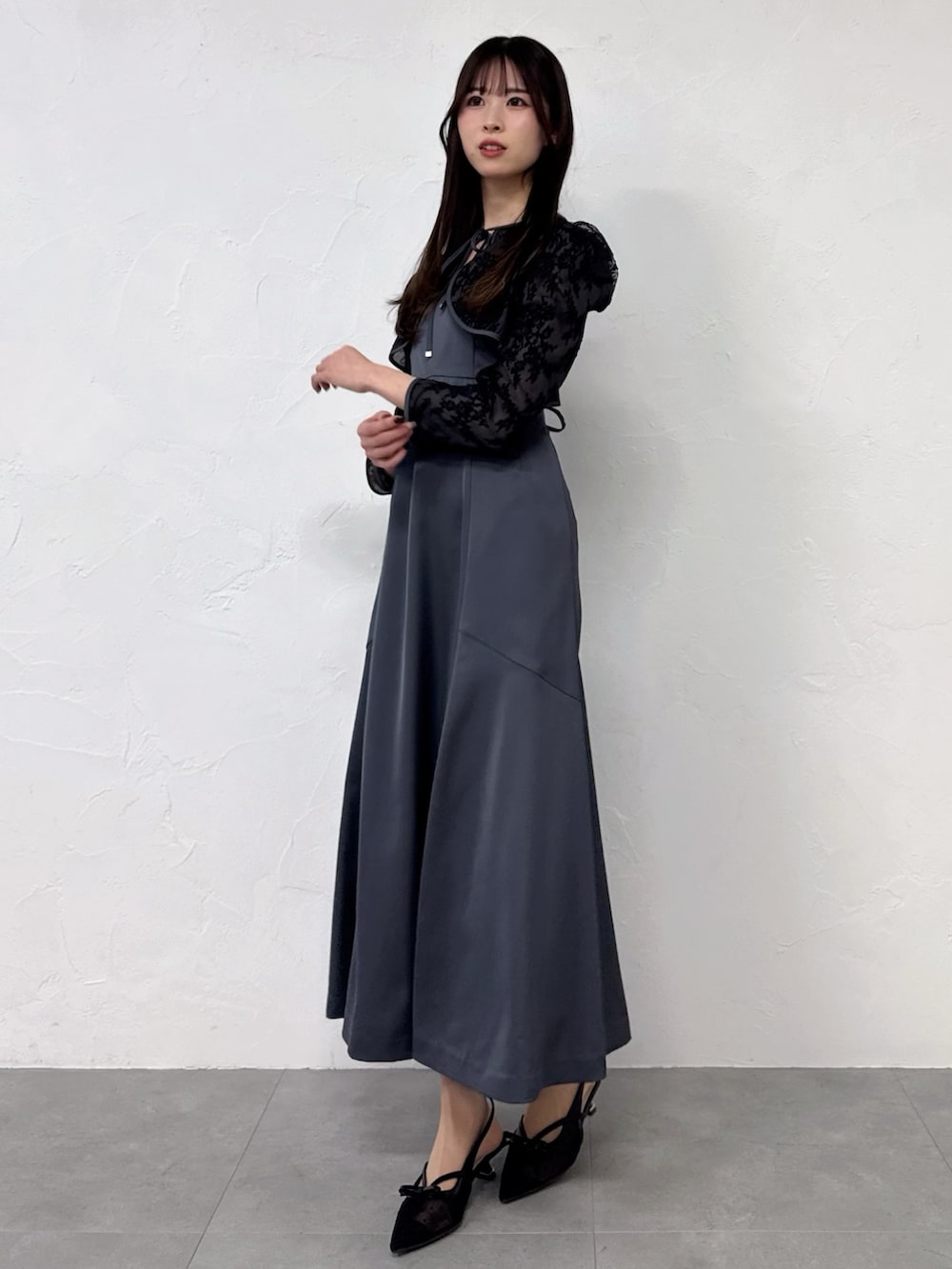 ブラック系のドレスを着用したレディースの冬コーディネートの2枚目の写真