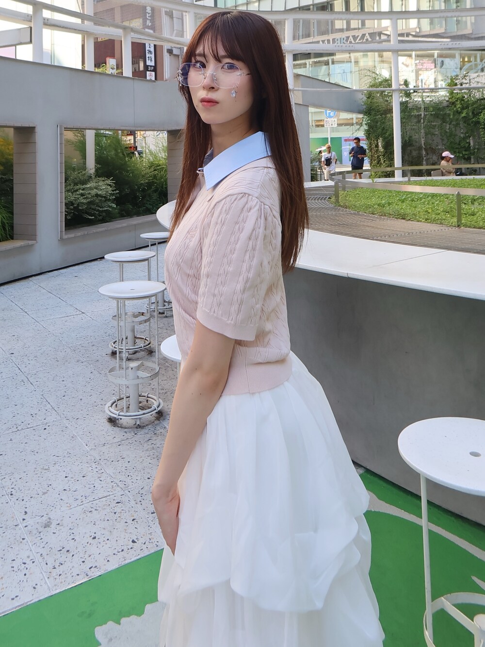 ピンク系のニット/セーター、ホワイト系のスカートを着用したレディースの夏コーディネートの6枚目の写真