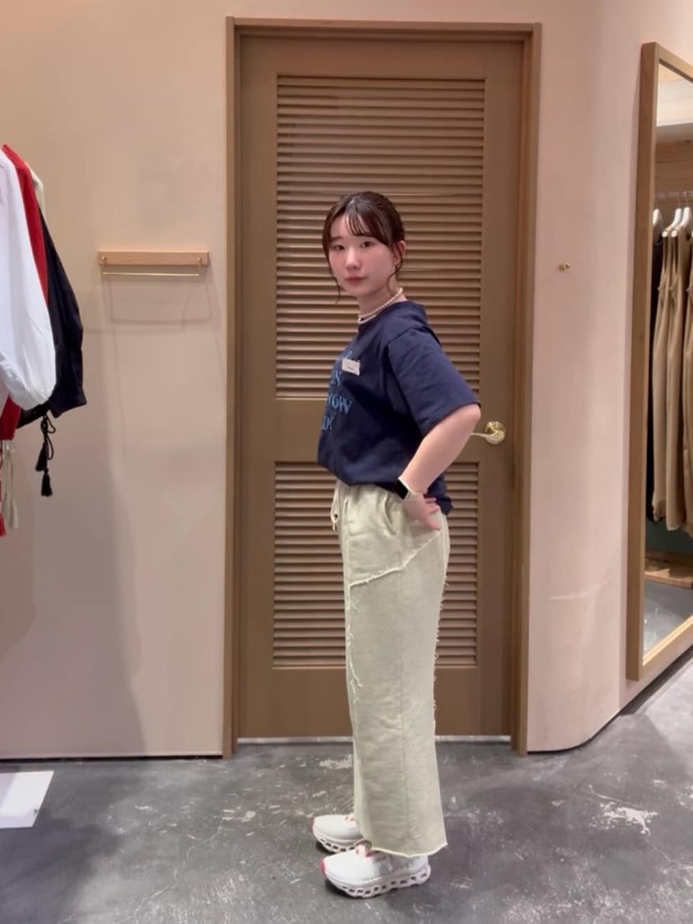 ブルー系のTシャツ/カットソー、イエロー系のスカート、ホワイト系のスニーカーを着用したレディースの秋コーディネートの2枚目の写真