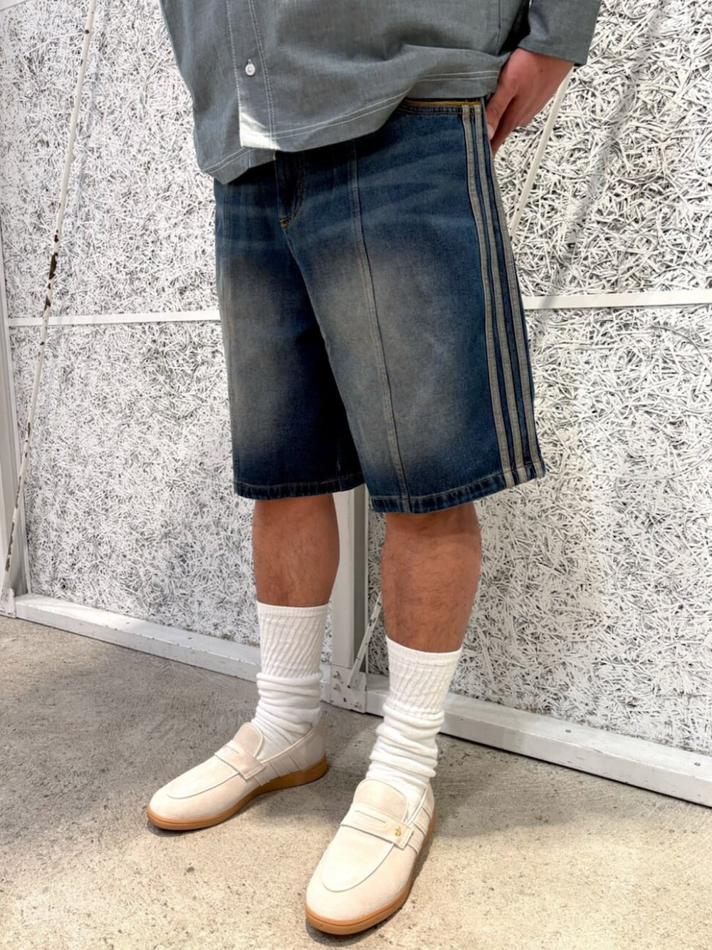 ブラック系のパーカー、グリーン系のトップス、ホワイト系のスニーカーを着用したメンズの冬コーディネートの5枚目の写真