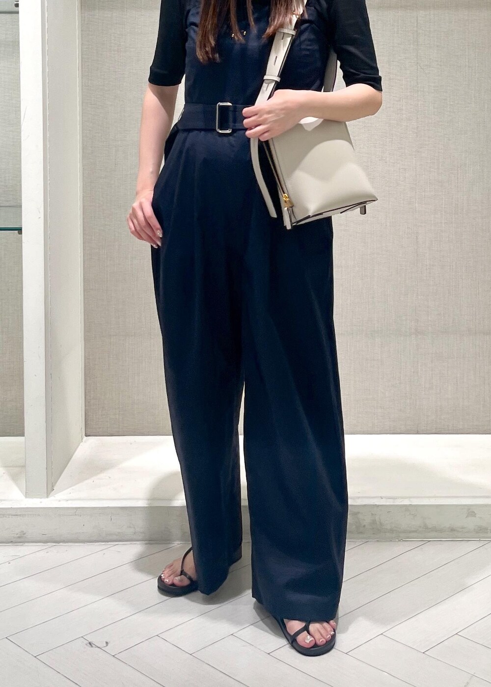 ブラック系のサンダル、ブラック系のTシャツ/カットソー、ブルー系のつなぎ/オールインワンを着用したレディースの夏コーディネートの6枚目の写真