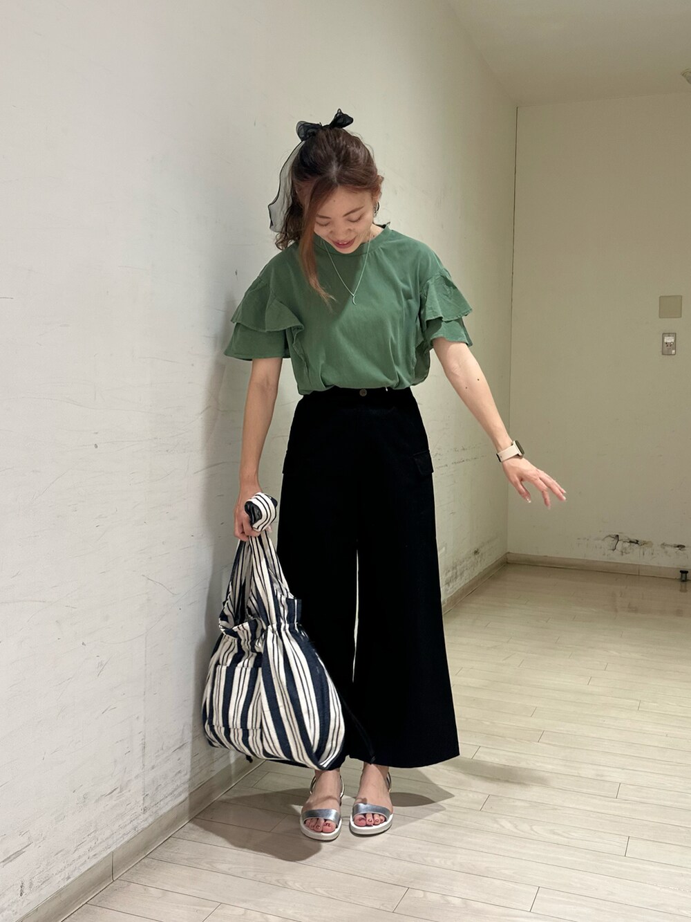 グリーン系のTシャツ/カットソー、ブラック系のその他パンツ、ブルー系のハンドバッグを着用したレディースの春コーディネートの4枚目の写真