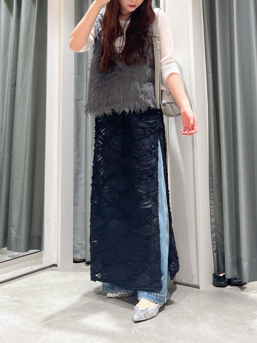 ブルー系のデニムパンツ、シルバー系のパンプス、グレー系のニット/セーターを着用したレディースの秋コーディネートの3枚目の写真