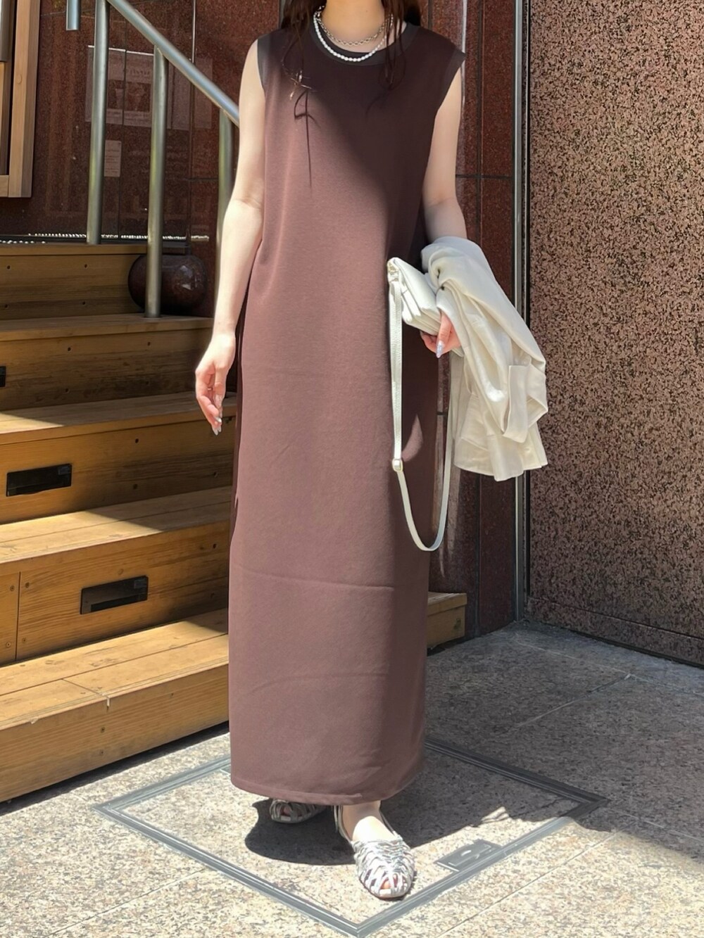 ブラウン系のワンピース、ホワイト系のシャツ/ブラウス、シルバー系のパンプスを着用したレディースの夏コーディネートの6枚目の写真