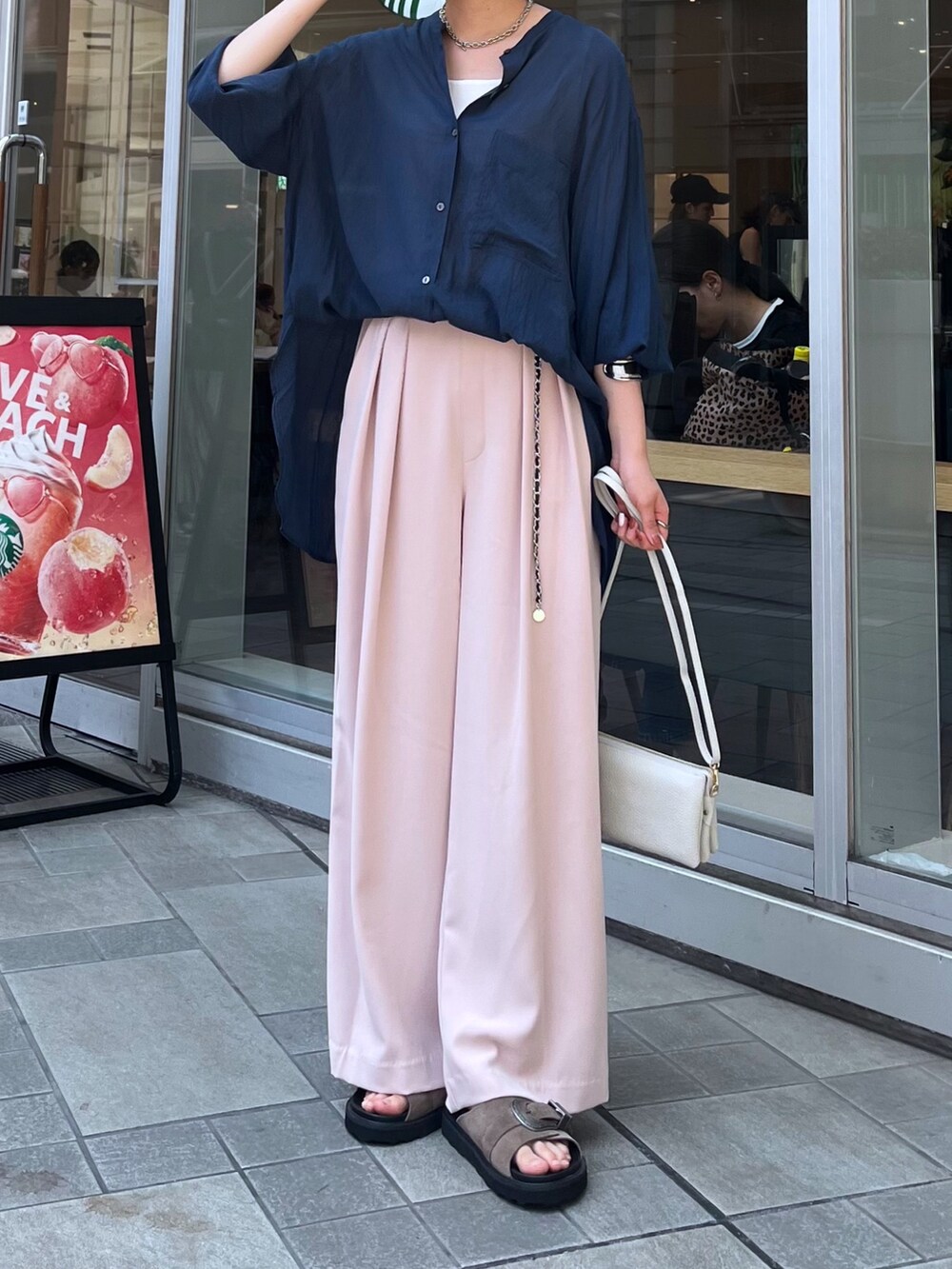 ピンク系のスラックス、ブルー系のシャツ/ブラウス、ホワイト系のタンクトップを着用したレディースの夏コーディネートの4枚目の写真