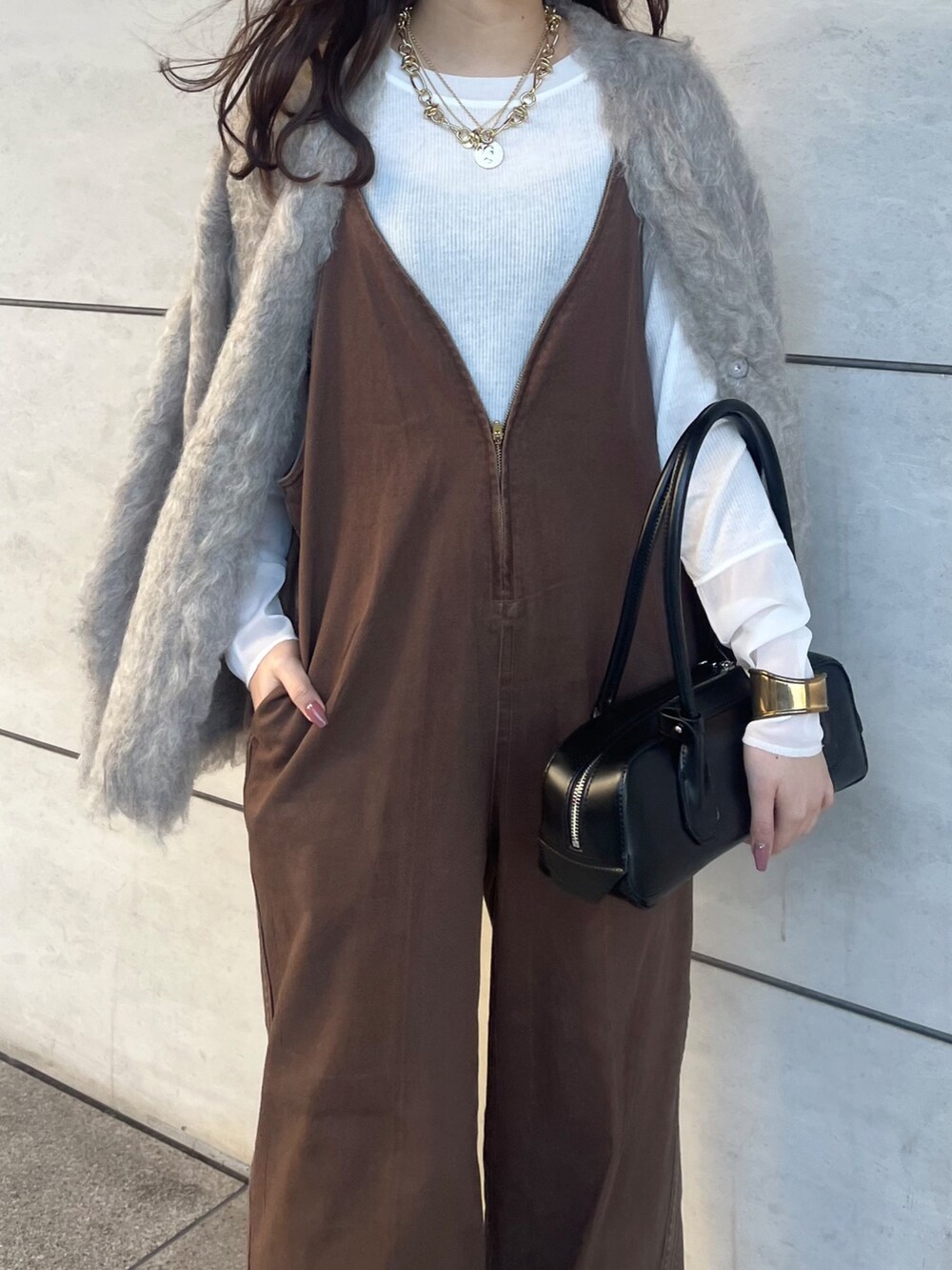 ブラウン系のつなぎ/オールインワン、ベージュ系のカーディガン/ボレロ、ホワイト系のTシャツ/カットソーを着用したレディースの秋コーディネートの5枚目の写真