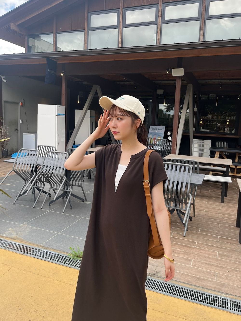 ブラウン系のワンピース、ブラック系のシューズ、ブラウン系のショルダーバッグを着用したレディースの秋コーディネートの4枚目の写真