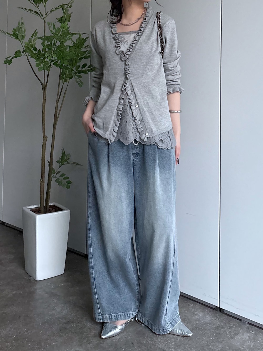 ブルー系のデニムパンツ、グレー系のカーディガン/ボレロを着用したレディースの冬コーディネートの2枚目の写真