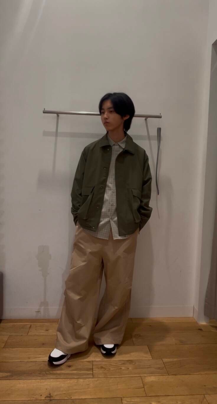 ホワイト系のスニーカー、グリーン系のブルゾン、ベージュ系のシャツ/ブラウスを着用したメンズの冬コーディネートの9枚目の写真